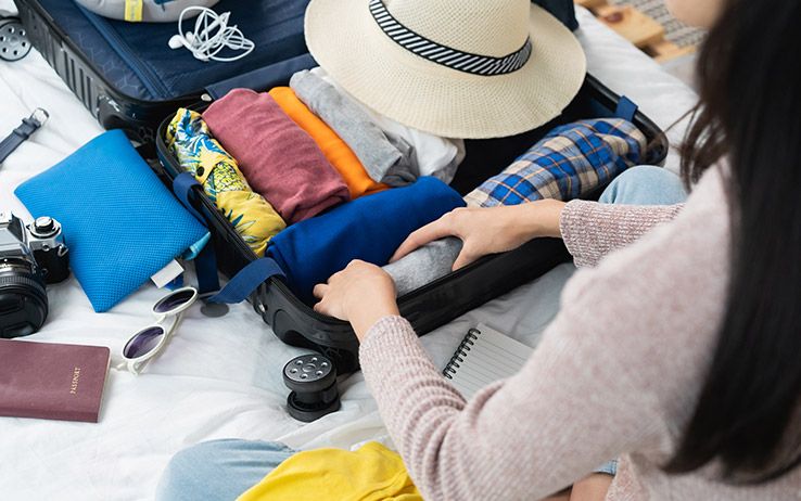 girl packing luggage for a week